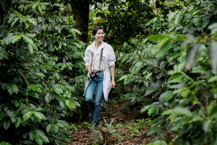 woman smiling in organic coffee field