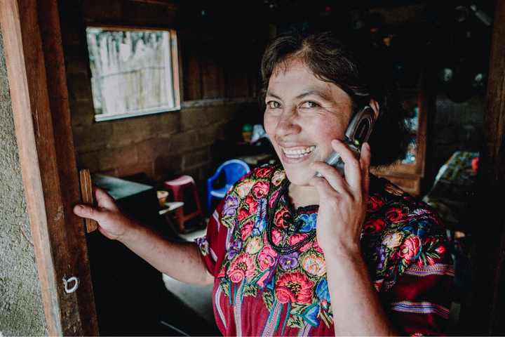 Caterina Yac, Guatemalan coffee producer smiles while on the phone