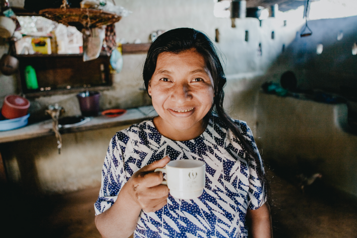 Sofia Vanegas, coffee farmer in Nicaragua, smiles over a cup of coffee
