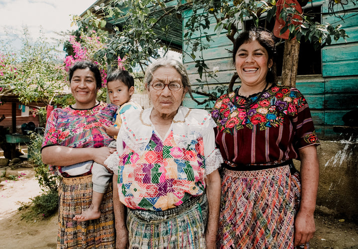 Catarina Yac, woman coffee farmer from Manos Campesinas in Guatemala poses with her family