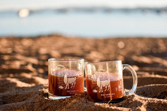 coffee mugs sit on beach 