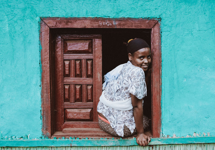 a child sits in window in Ethiopian town 